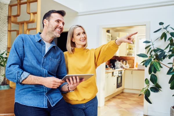 iStock Credit: BaretkSzewczyk A woman and a man planning a living room layout